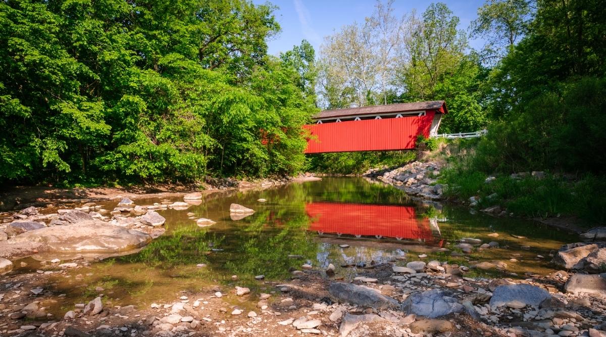 The Everett Road Covered Bridge is a historic wooden covered bridge located in the Cuyahoga Valley National Park in Ohio. The bridge has an urban truss design, red in color with a brown roof.