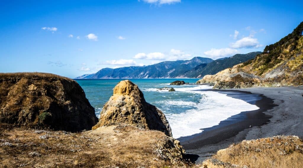 Black Sands Beach is a secluded beach located in the King Range National Conservation Area of California. It is a stunning black sand beach surrounded by high cliffs with stunning ocean views and hiking opportunities.