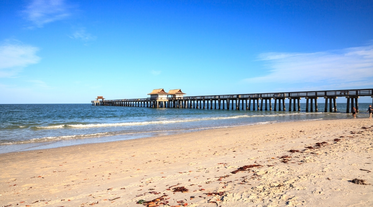 Naples Beach is a picturesque stretch of coastline on the Gulf of Mexico, with powdery white sand and clear blue waters. It features a historic pier for fishing and stunning sunsets.