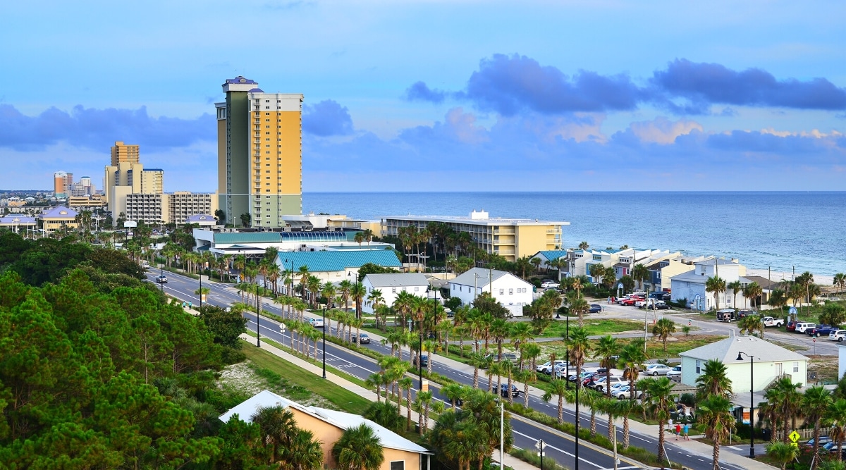 Panama City Beach is a popular vacation destination located in the northwest region of Florida. Top view of beautiful beach area with clean stunning white sand beach, clear turquoise water and warm Gulf Coast climate. The city also has a variety of shops, restaurants and entertainment venues.