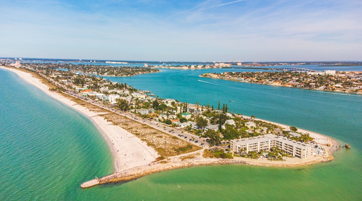Pass-a-Grille Beach is a picturesque, white-sand beach located at the southern end of St. Pete Beach in Florida. Top view of beautiful clear blue waters, soft white sand coastlines and a variety of hotels, bars, shops.