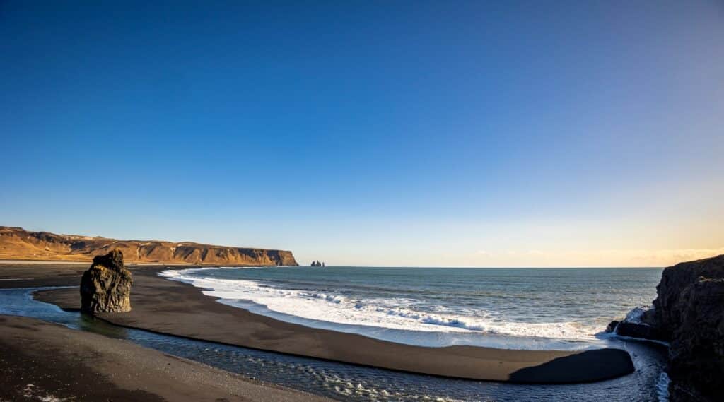 Reynisfjara is a famous black sand beach in Iceland, famous for its unique basalt cliffs, high cliffs and powerful waves. The black sand of the beach consists of eroded volcanic rocks, and the basalt columns were formed as a result of the cooling of lava flows.