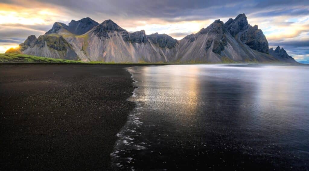 Stokksnes is a beach located on a peninsula in southeastern Iceland. It is known for its stunning black sand dunes and stunning views of the Vestrahorn mountain range.
