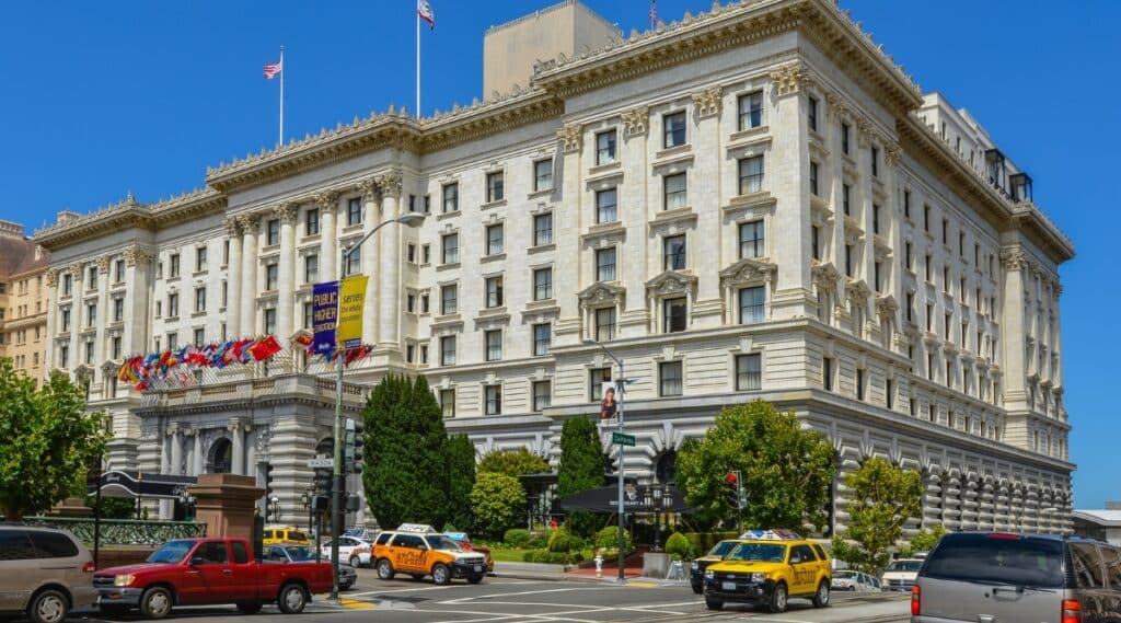 Fairmont Hotel in San Francisco with cars driving around the location.
