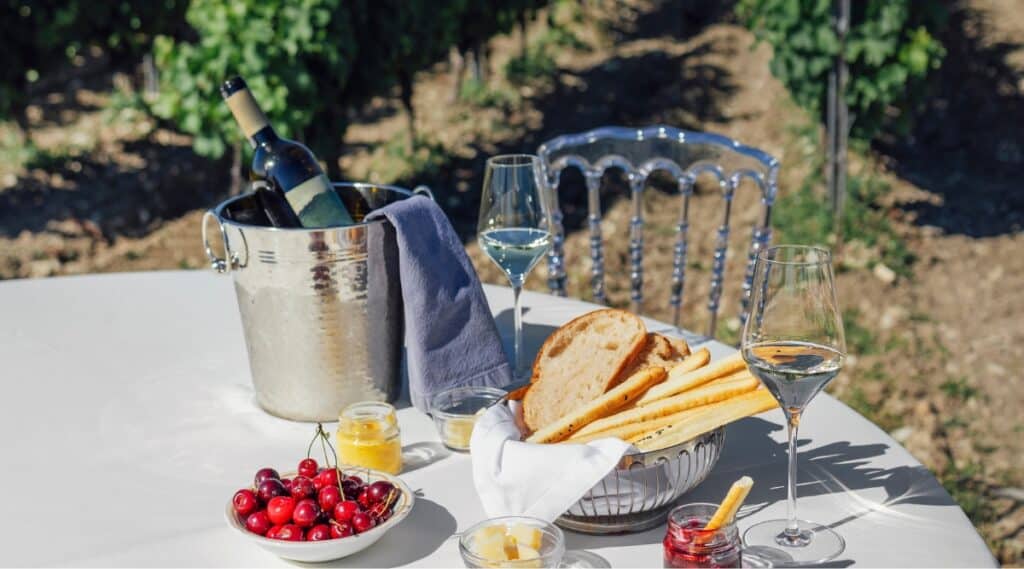 A lovely picnic of fresh berries, wine, bread and cheese among the vineyards in Napa Valley.