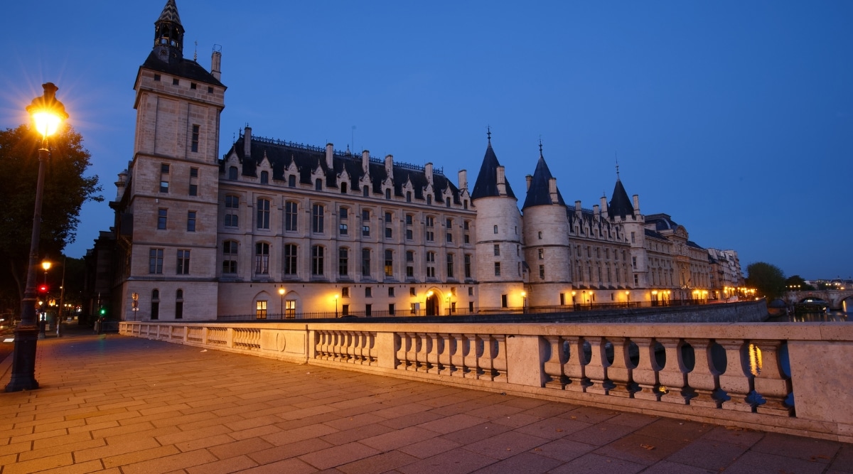 The Conciergerie exterior photographed at nighttime in Paris France.