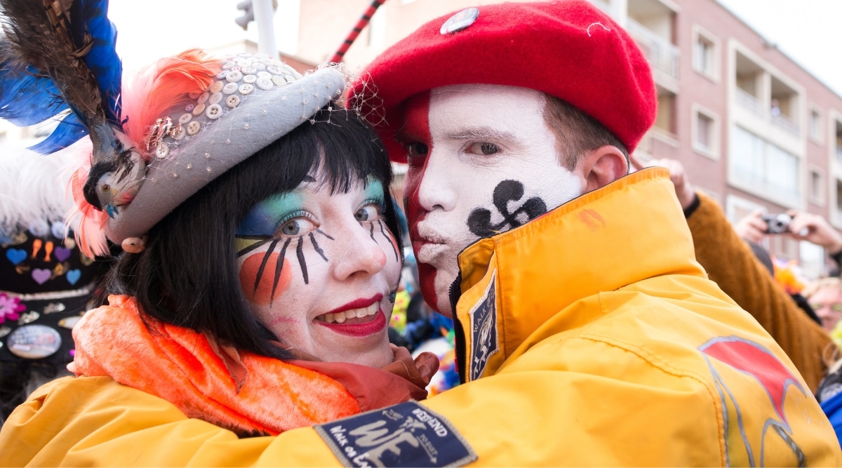 Close up of a couple with face paint and costumes celebrating the Dunkirk Carnival.