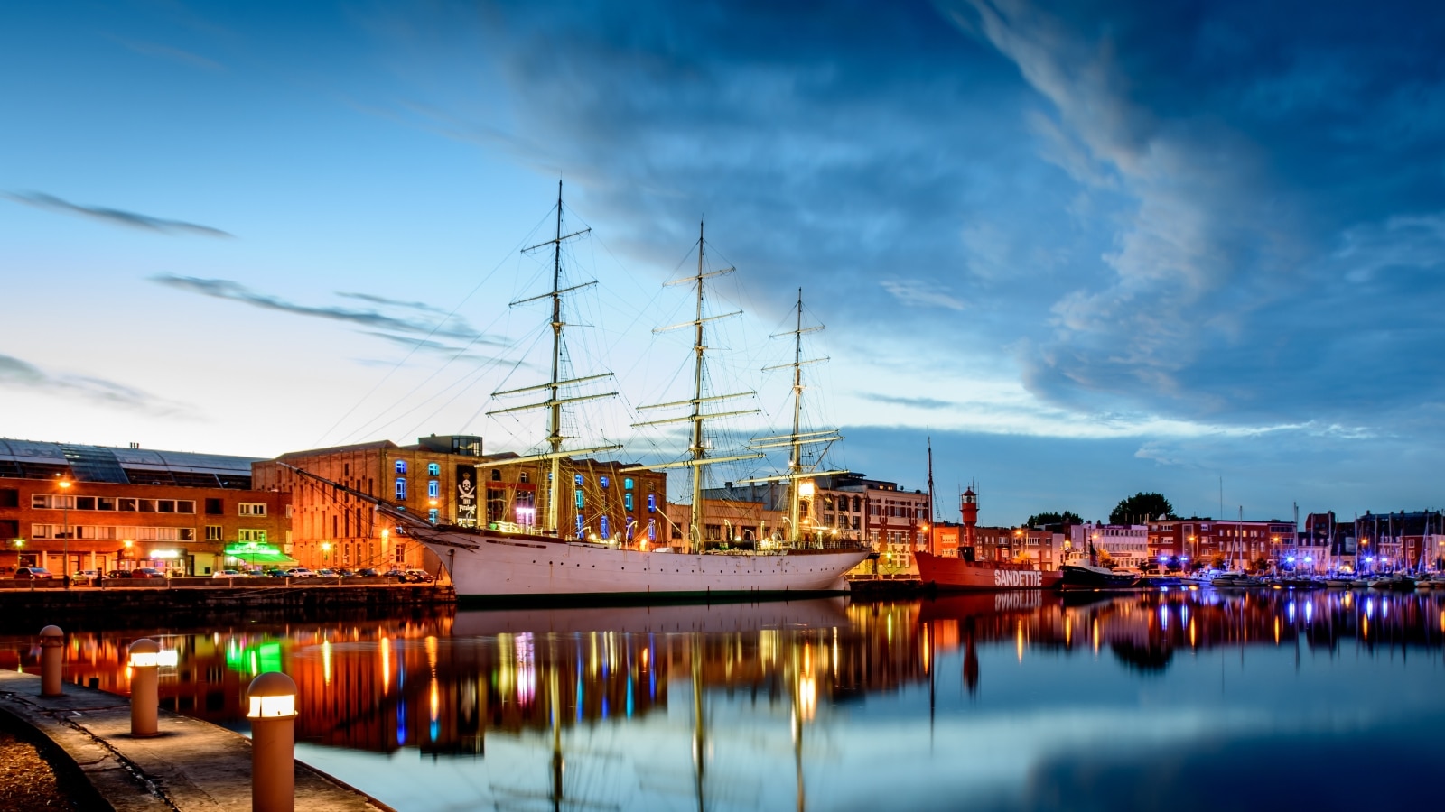 Dunkirk port at sunset lit up.