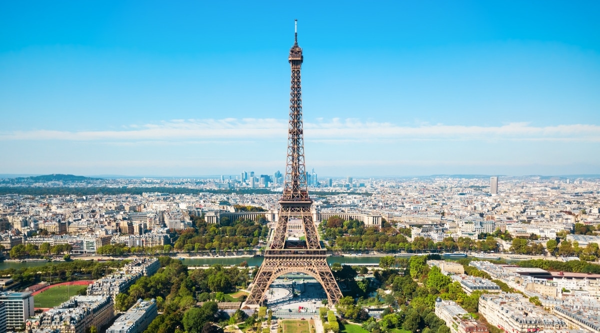 Aerial view of the Eiffel Tower. The Eiffel Tower is an iconic Parisian landmark, characterized by its towering iron lattice structure. Its iron beams create a mesmerizing grid pattern, and the tower is divided into three levels, each offering spectacular views of Paris.