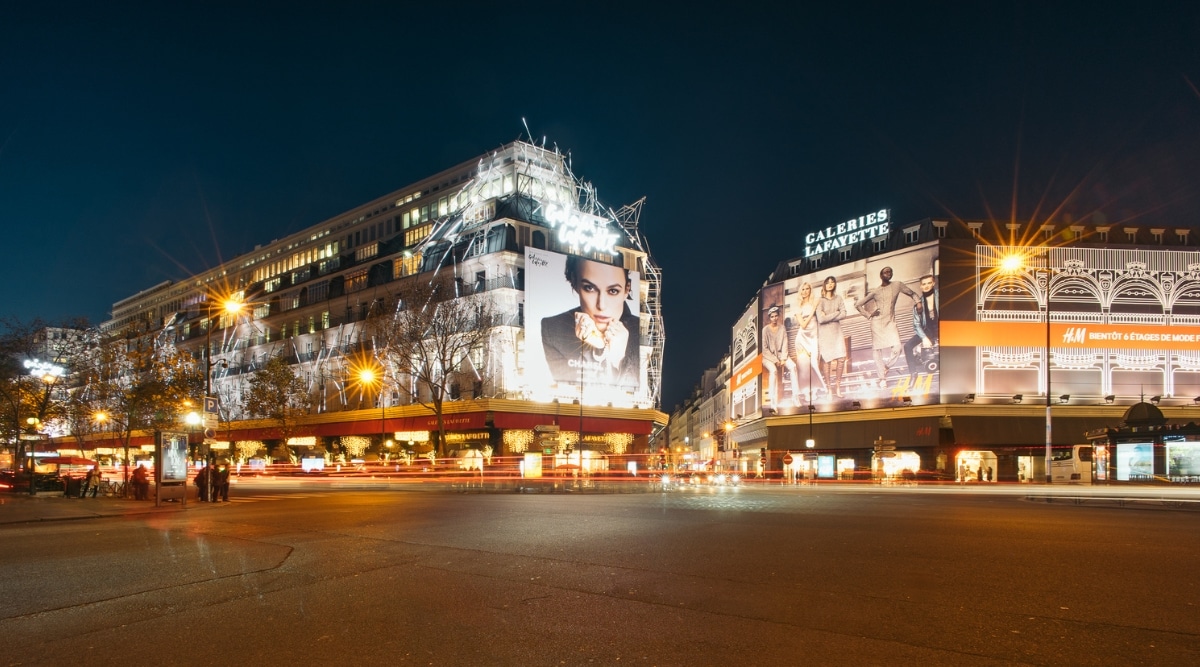 The Galeries Lafayette Paris Haussmann in Paris, France, photographed from the street lit up at night. 