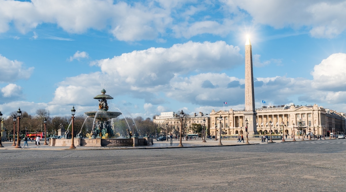 Bright sunny summer day view of Luxor Obelisk and Maritime Fountain at Place de la Concorde in Paris, France.