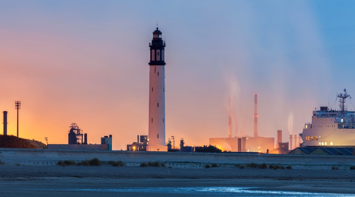 The Risban Lighthouse in Dunkirk France, photographed at sunset from a distance.