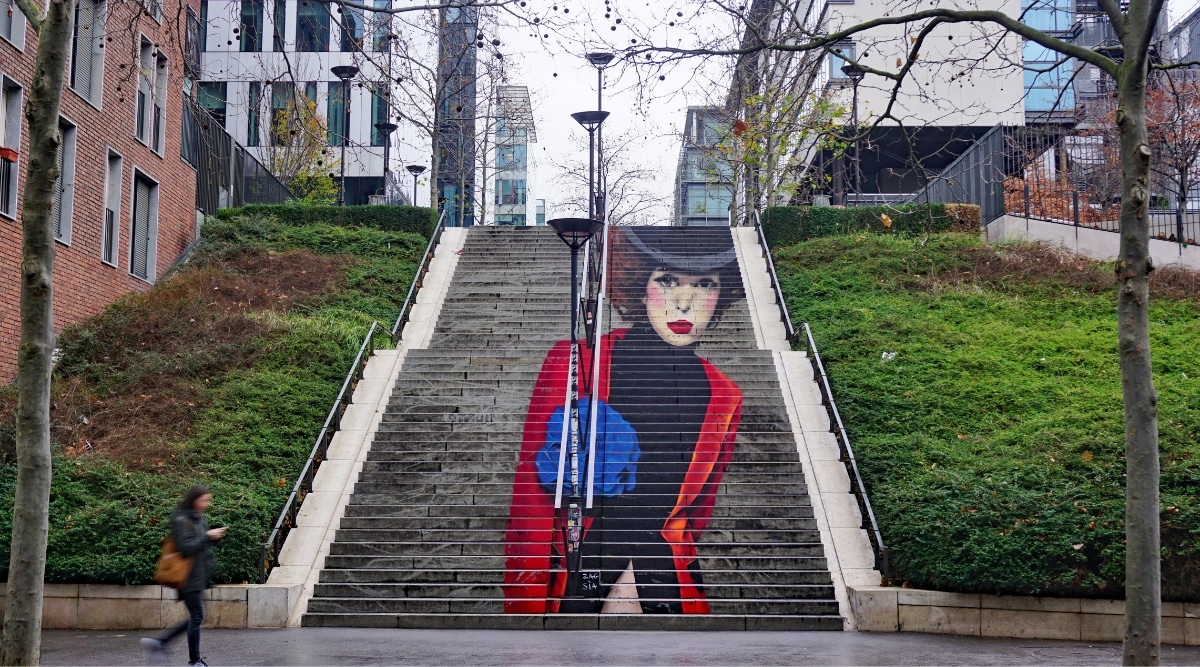 La Parisienne street art painting on a staircase in Paris France.