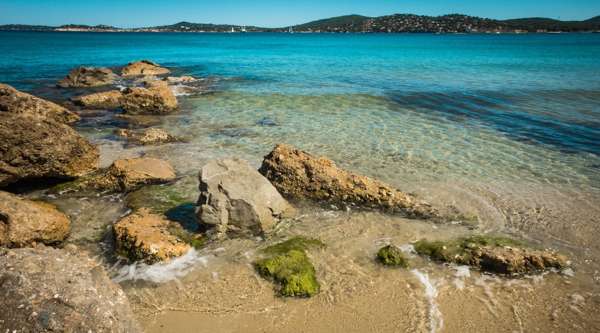 Close up of a clear water beach in St Tropez France on a sunny summer day.