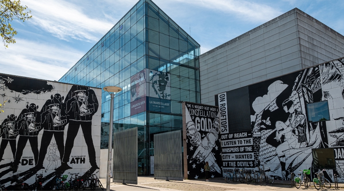 The exterior of the Musee d’Art Moderne in Strasbourg, France on a clear, sunny summer day.