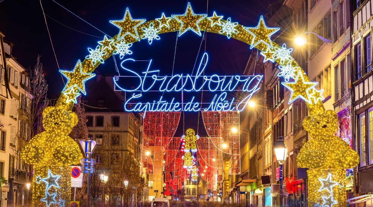 The festive Strasbourg Christmas Market lights, lit up for the holidays at night in Strasbourg, France.
