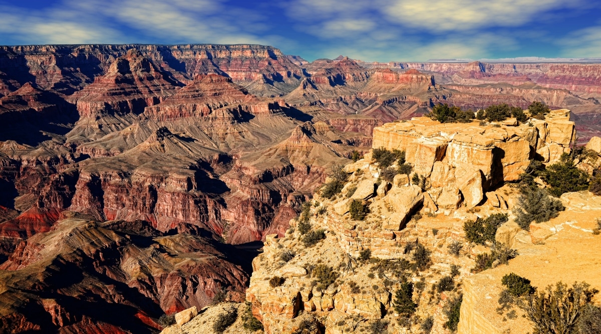 View of Grand Canyon National Park. The Grand Canyon National Park sprawls majestically across the frame, revealing its immense depth and layered red rock formations.
