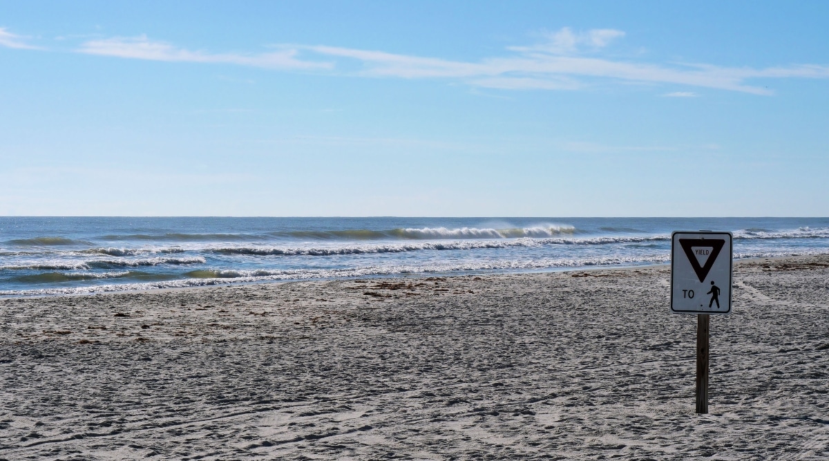A photograph capturing Crescent Beach in St. Augustine, Florida. The image showcases the sandy shoreline along the Atlantic Ocean.
