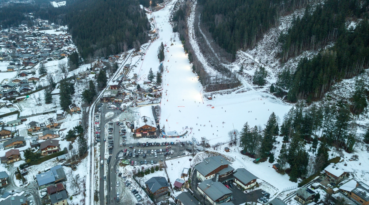 An aerial view of Domaine des Planards, a recreational area in Chamonix, France, reveals lush greenery encompassing the space.