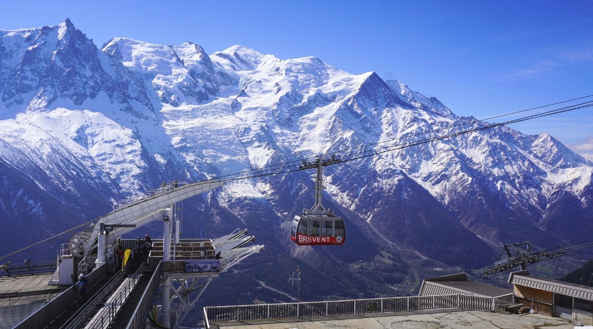 An exhilarating image showcases the ascent to the mountain Le Brévent in Chamonix, France, via a scenic lift. The lift, with its sturdy cables and comfortable cabins, transports visitors from the valley floor to the breathtaking heights of Le Brévent. Towering alpine peaks surround the lift, offering a stunning panorama of the French Alps.