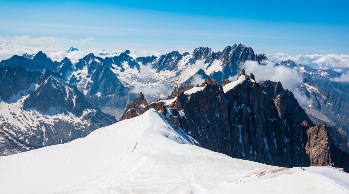 Mont Blanc in Chamonix, France, offers a breathtaking image that captures the essence of the majestic Alps. Towering over the Chamonix Valley, Mont Blanc's snow-capped peaks create a stunning contrast against the vibrant blue sky. 