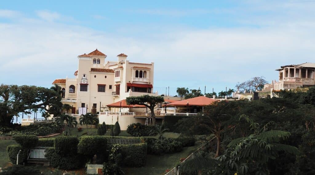 A photograph featuring Museo Castillo Serralles in Puerto Rico. The image displays the exterior of the museum, showcasing its architectural features against a backdrop of clear skies. The building is characterized by its classic design and subtle detailing.