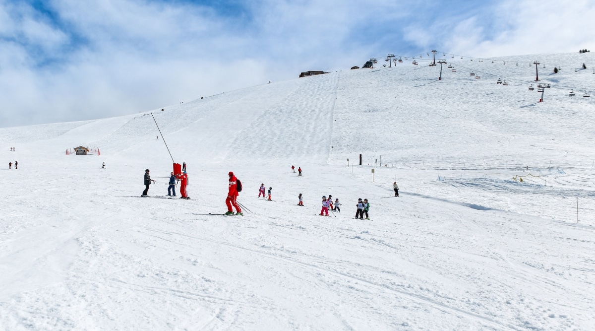 In Chamonix, France, skiers donning vibrant winter gear navigate the slopes. The crisp mountain air and pristine snow combine to create a picturesque and invigorating atmosphere.