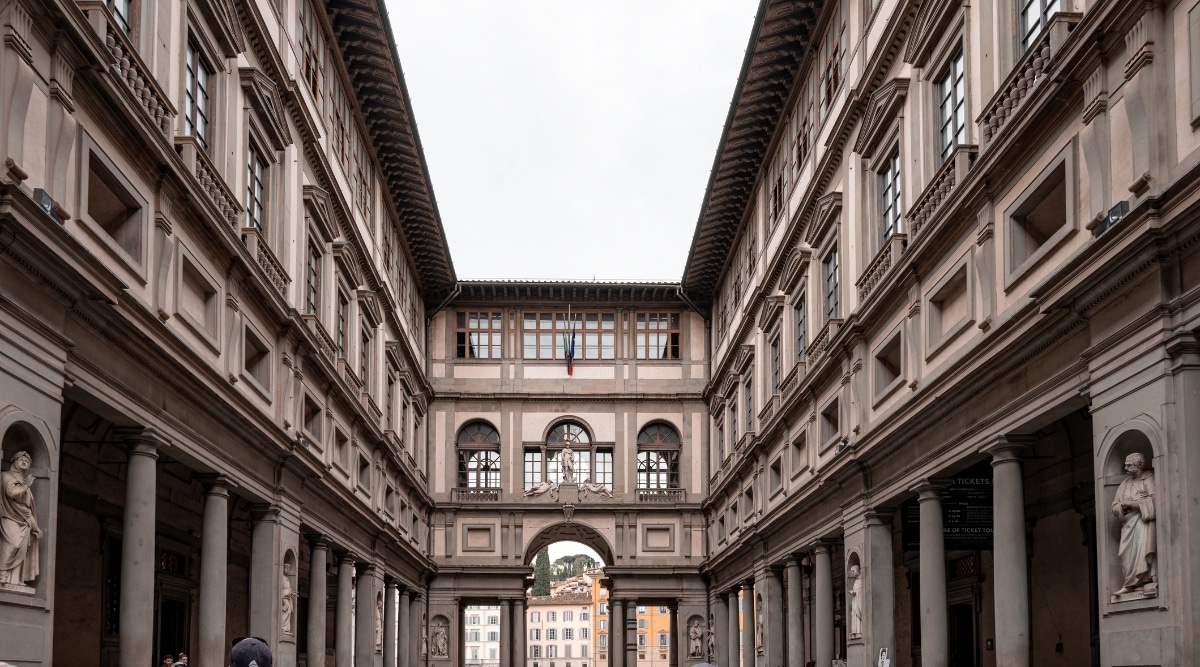 Uffizi Gallery in Florence, Italy. The image showcases the historic facade of the gallery, adorned with intricate architectural details. The iconic U-shaped building. The exterior of the Uffizi Gallery, with its classic arched windows and ornate sculptures, creates an air of timeless elegance.