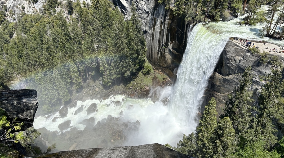 A photograph capturing Vernal Fall in California. The image portrays the waterfall within Yosemite National Park, surrounded by natural rock formations and lush vegetation.