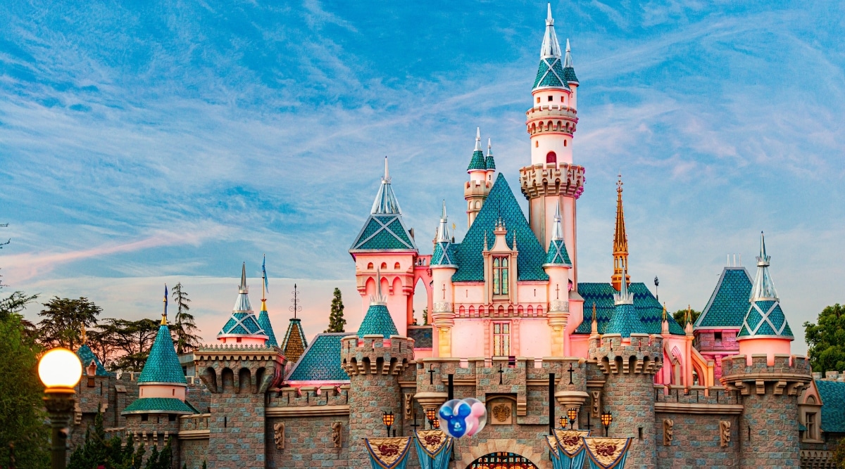 The image presents the architectural elements without embellishment, showcasing the distinctive design of the theme park. The castle, a focal point, stands tall with identifiable blue lids.