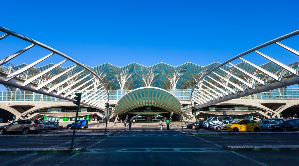 A photograph depicting Gare do Oriente in Lisbon. The image showcases the modern architectural design of the train station, characterized by sleek lines and contemporary elements.