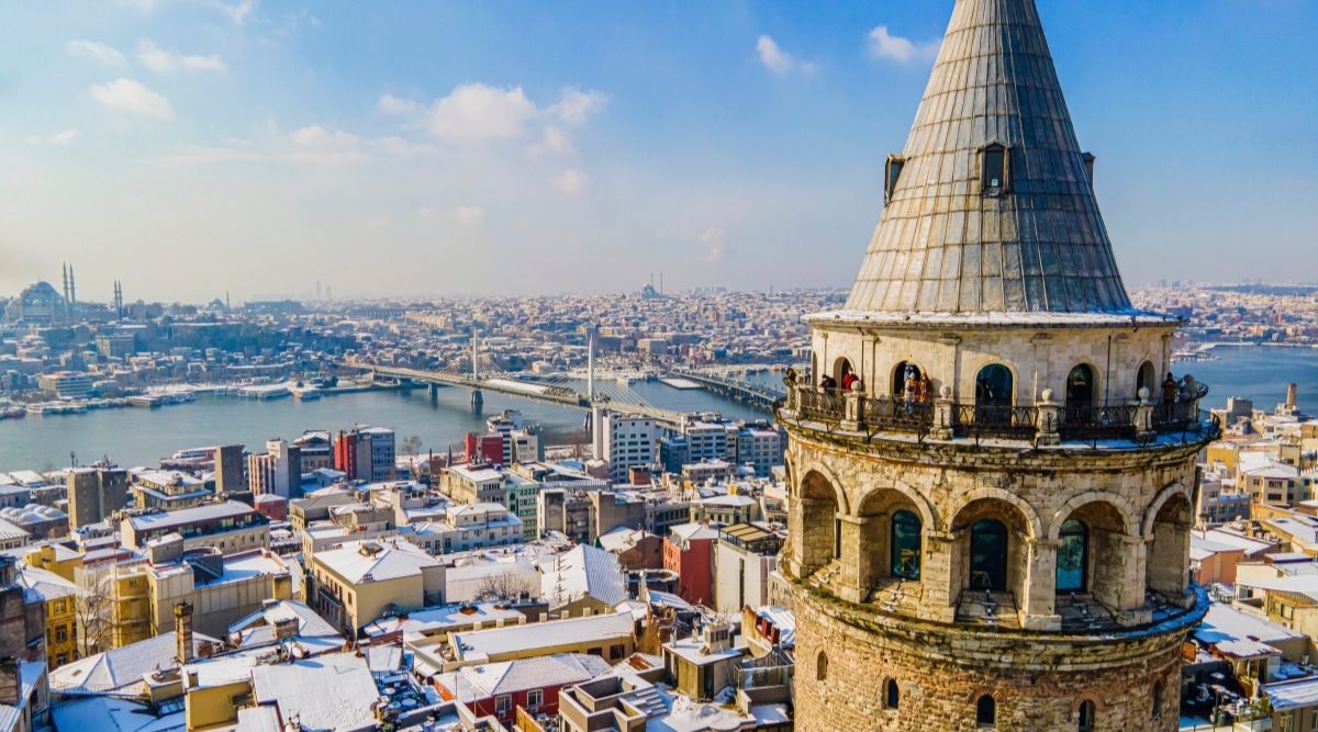 A drone photograph capturing winter landscapes along the Bosporus in Istanbul, Turkey. The image features the iconic Istanbul Icons Bridge and Towers, presenting a visual panorama of the city's architectural elements.