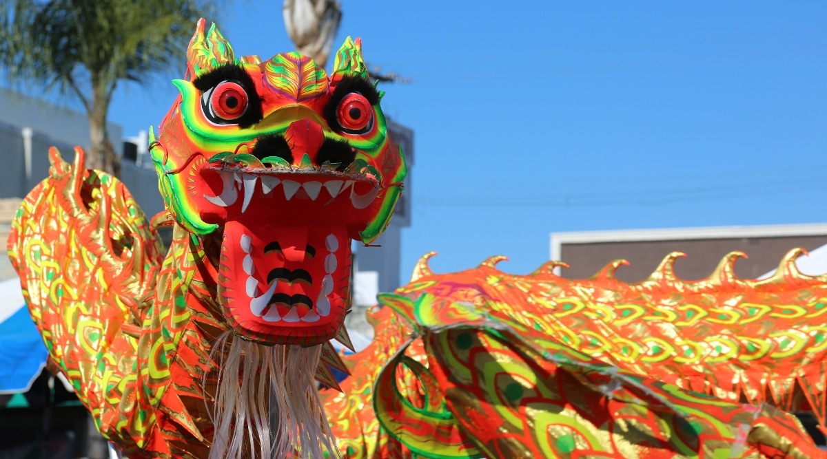 A close-up photograph capturing a large dragon displayed during the Lunar New Year Festival in Los Angeles. The vibrant colors and elaborate design contribute to the visual appeal of the festival display.