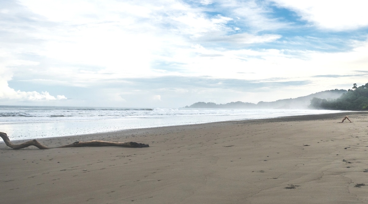 An image capturing an empty Mattole Beach in Humboldt County, characterized by overcast skies and small ocean waves. 