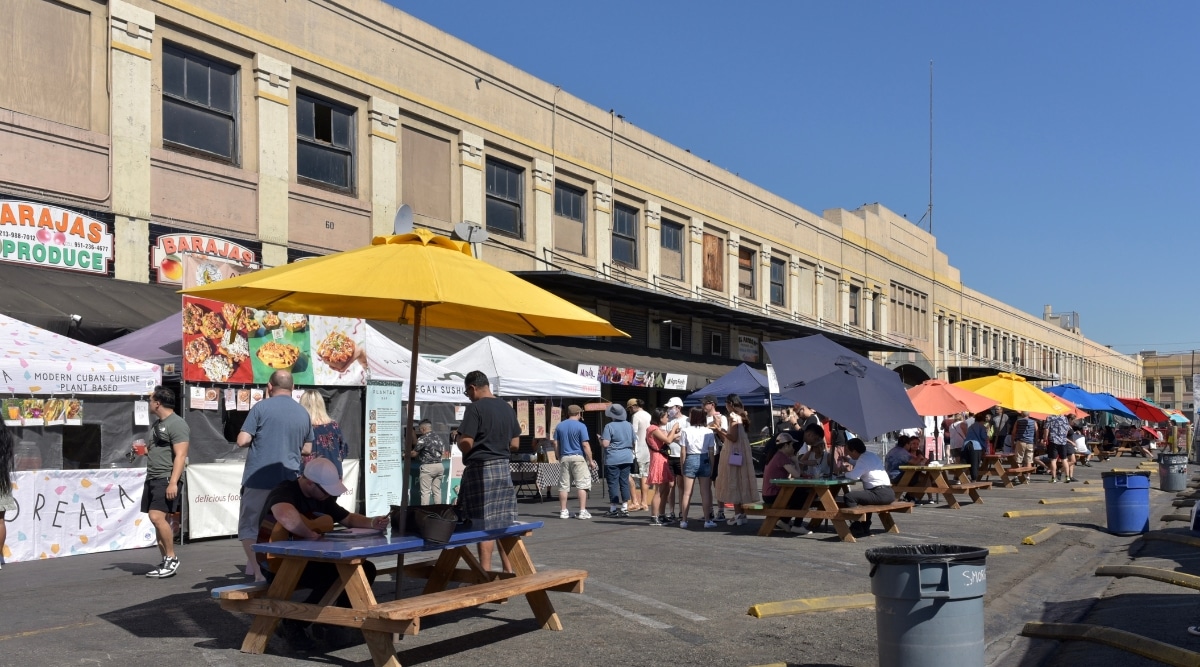A photograph depicting Smorgasburg Los Angeles, a popular outdoor food market. The image captures various food stalls and visitors exploring the offerings.