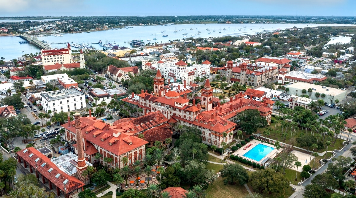 A top view capturing the cityscape of St. Augustine, Florida, characterized by buildings with red roofs. The image provides an overview of the urban layout, showcasing the architectural elements and the prevalence of red-roofed structures. The city's layout appears organized, with streets and buildings forming a typical urban pattern.