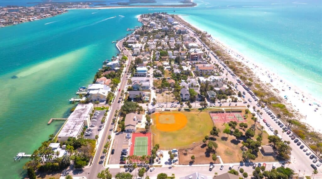 A top view capturing the cityscape of St. Petersburg/Clearwater, Florida. The image provides an aerial perspective of the urban layout, featuring streets, buildings, and water bodies. The city is seen in a neutral weather condition, with no distinct atmospheric elements.