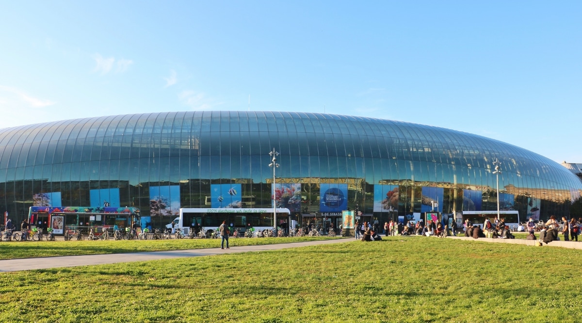 Strasbourg Ville Train Station, a blend of historical and modern architecture. The station's exterior exudes a mix of old-world Renaissance style and contemporary design, resembling a modern art museum. The glass enclosure serves as a protective shield, encapsulating the stately building.