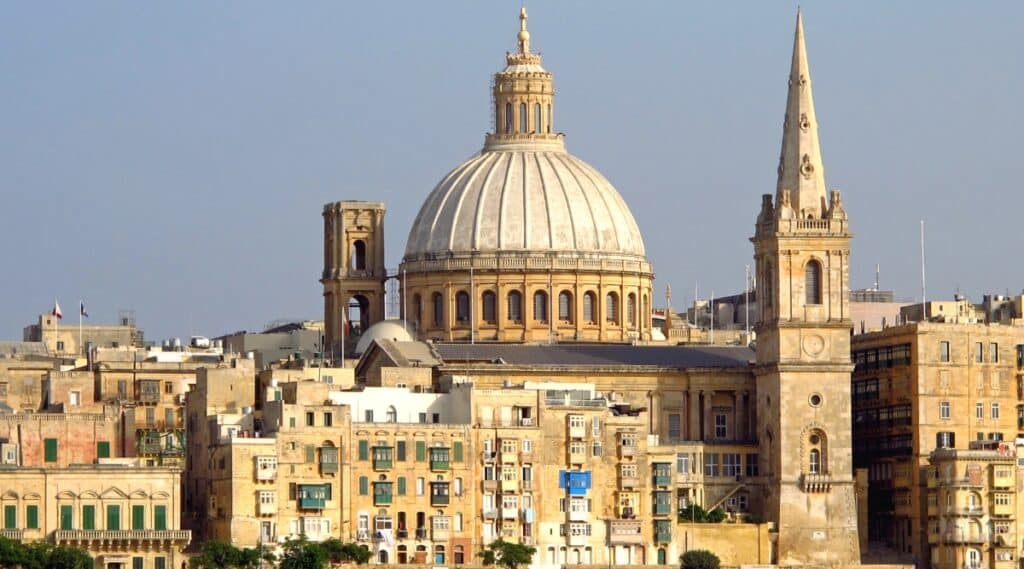 A view capturing the ancient city of Valletta, Malta. The image showcases the cityscape, featuring historical architecture, fortified walls, and the unique layout of Valletta. Notable landmarks and buildings are visible.