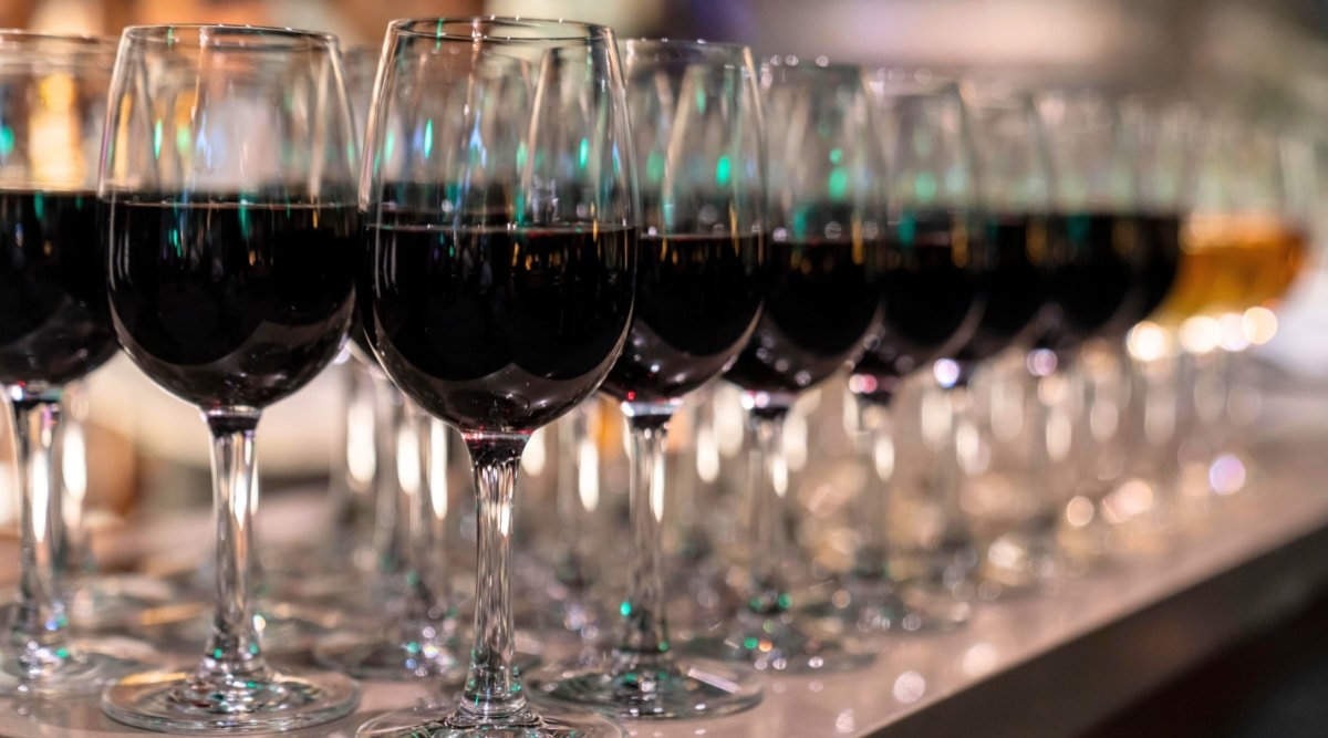 A photograph capturing wine glasses arranged on a table in Los Angeles. The image displays the glasses filled with red wine, positioned neatly.