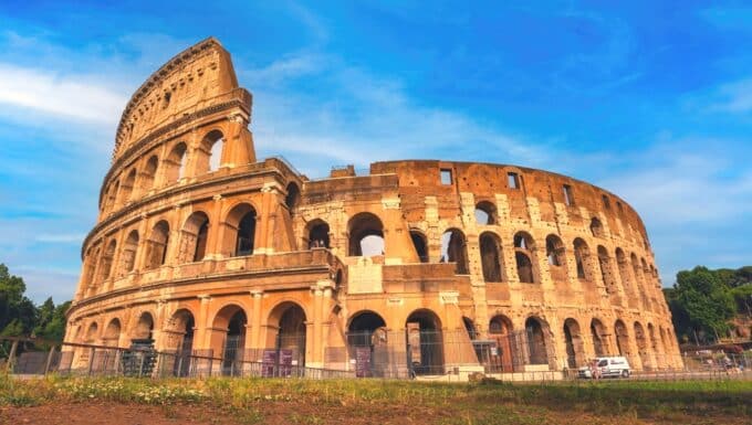 The Flavian Amphitheatre, commonly referred to as the Colosseum, depicted in its archaeological context in the heart of Rome. The image captures the iconic structure