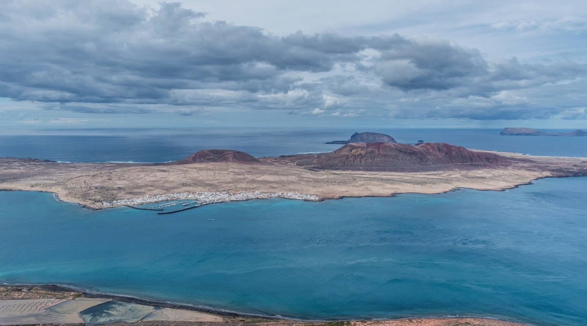 A view of the small island of La Graciosa from the Mirador del Rio on Lanzarote, Canary Islands, Spain. The image captures the landscape with La Graciosa in the distance, showcasing its topography and coastal features.