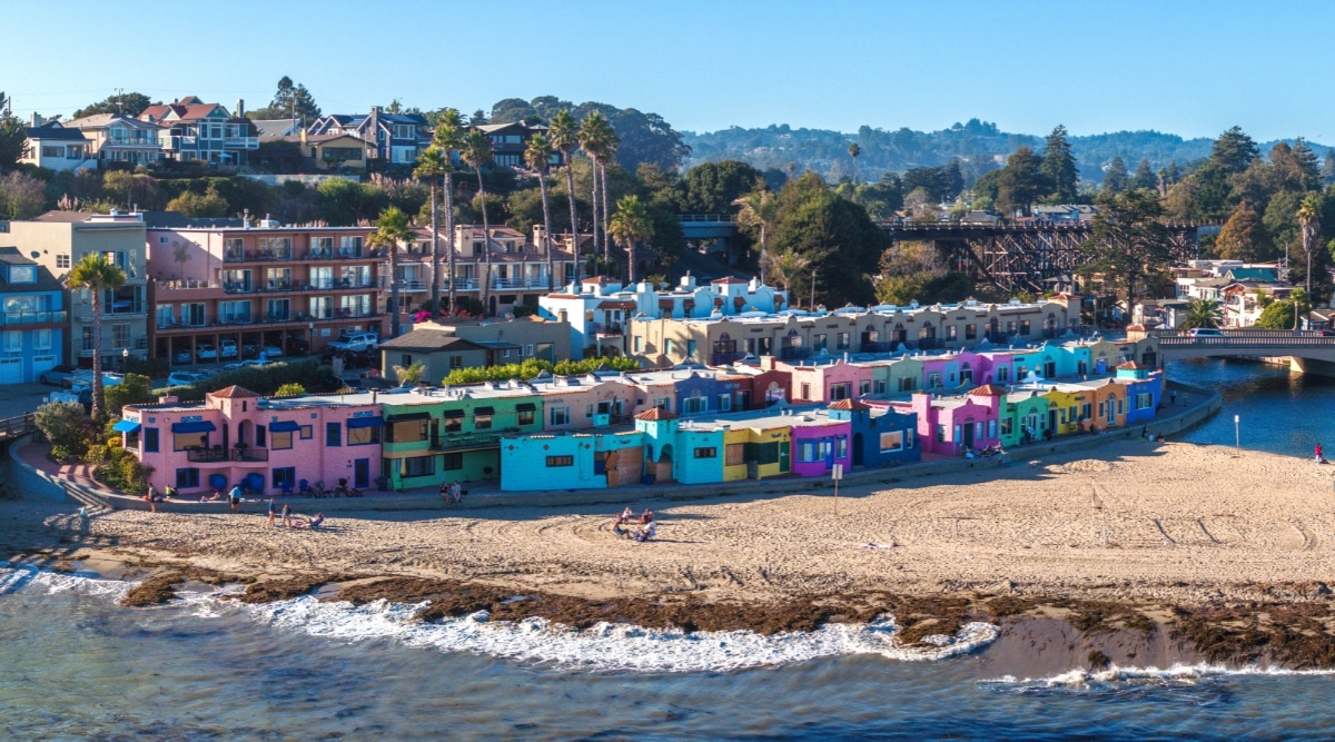 An aerial view capturing the expanse of Capitola beach town in Santa Cruz, California. The image showcases the town's layout, with coastal architecture lining the shoreline. The beach, marked by its sandy expanse.