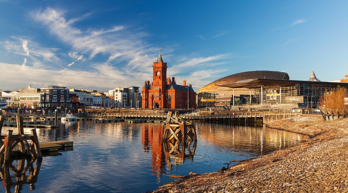 A photograph capturing the waterfront at Cardiff Bay in Wales, UK. Cardiff Bay's waterfront, characterized by its architectural features, is visible in the background.