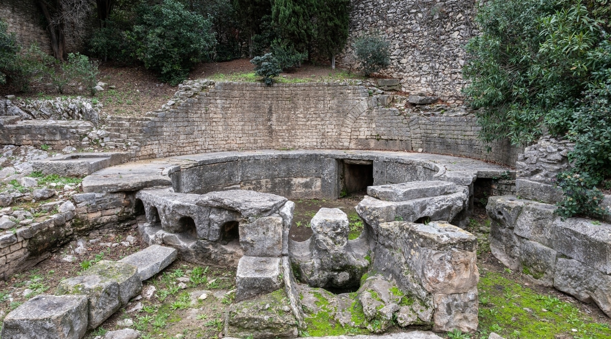 A photograph showcasing the decorated details of art and sculptures at the Fountain Gardens of Castellum Aquae in Nimes.