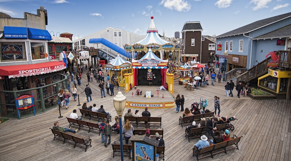 Center Stage on Pier 39 Fisherman's Wharf in San Francisco CA. People seated watching a magic show.