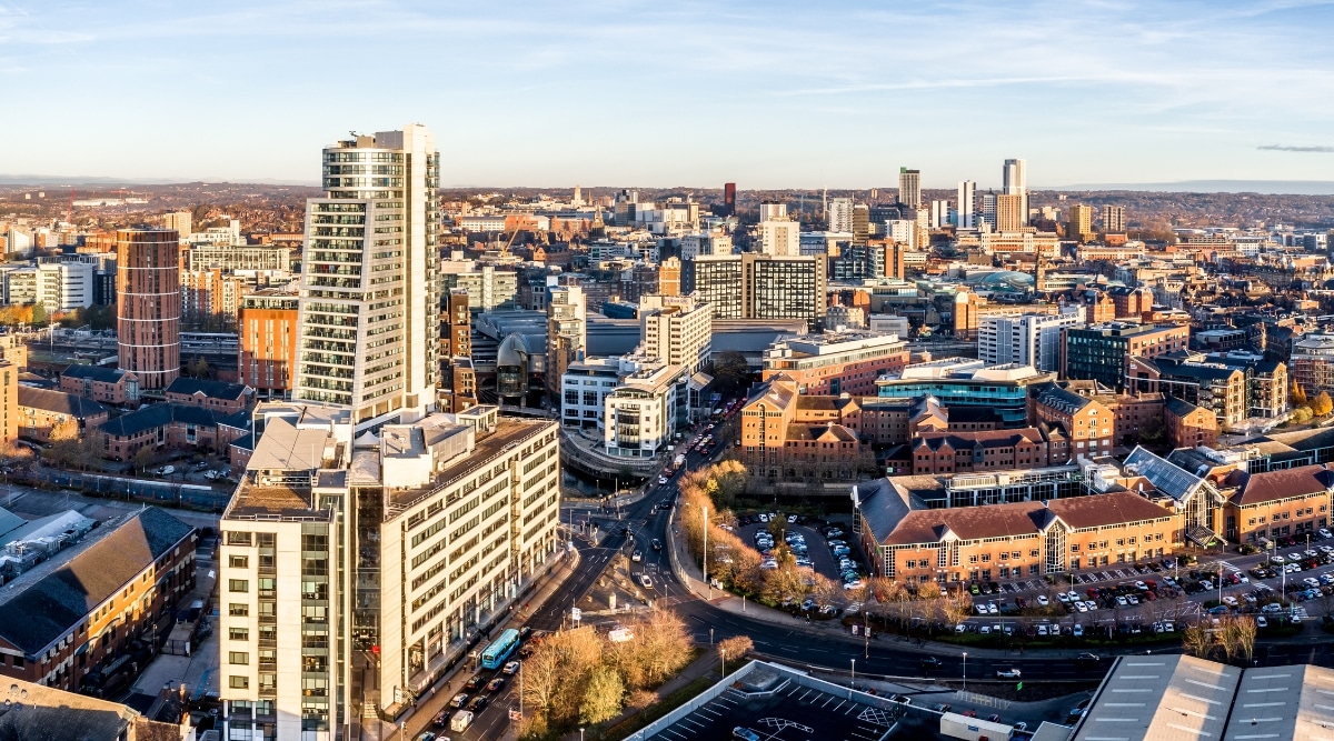 An aerial panorama capturing the Leeds city skyline, featuring prominent landmarks including the Bridgewater Place building and the retail district. The image provides an expansive view of the urban landscape, showcasing the architectural elements of the city.