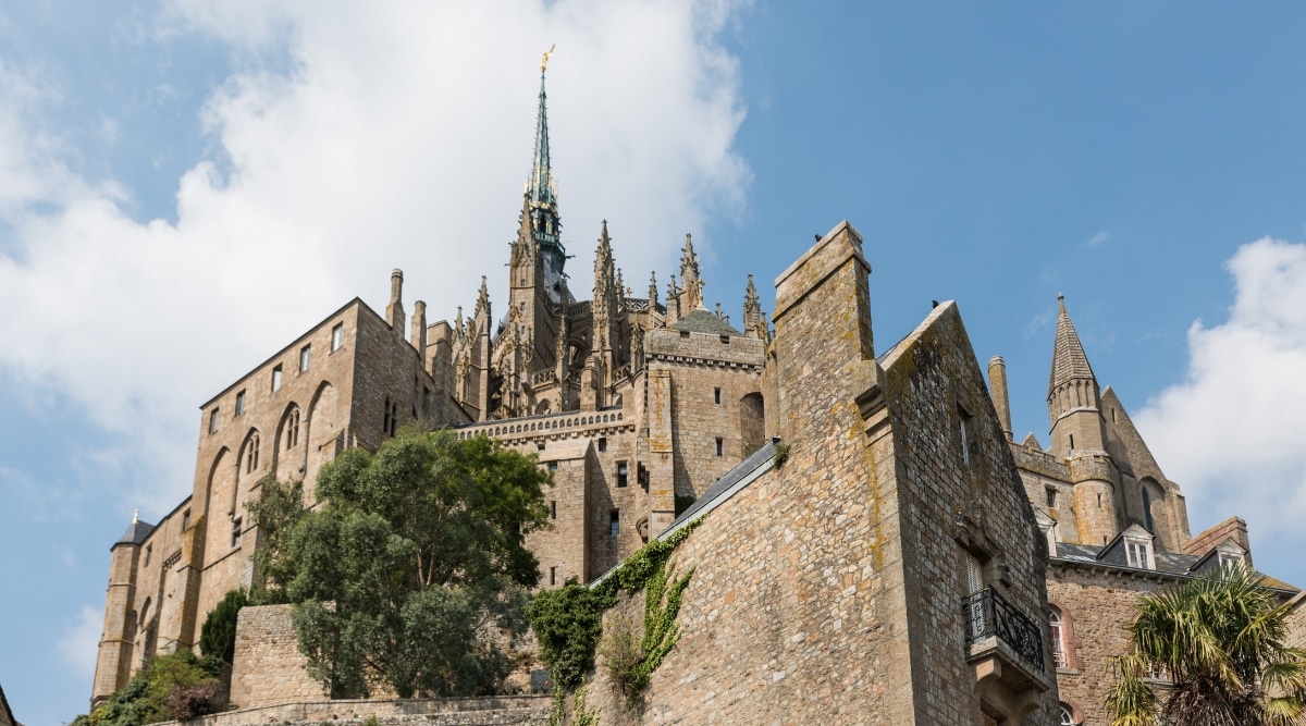 The Abbey at Mont Saint Michel photographed from below looking upwards on a bright sunny day in France.