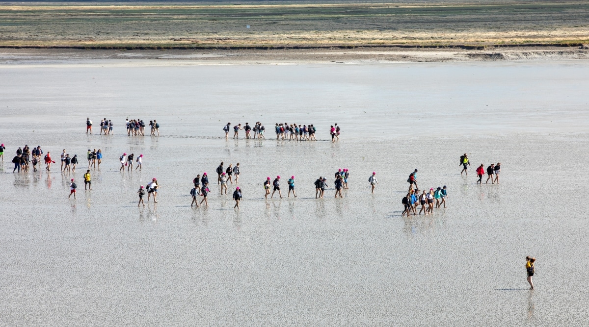 Groups of tourists being guided through the bays at Mont Saint Michel as the tides begin to return.