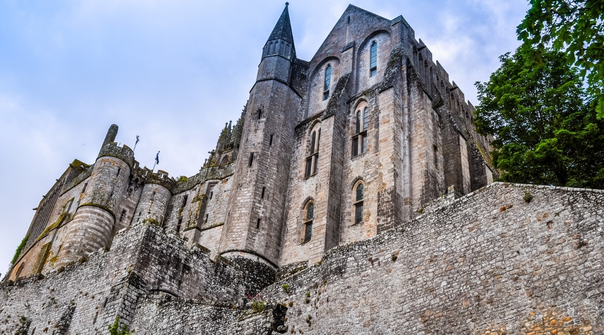 Stone staircase going to Mont-Saint-Michel abbey, France on a cloudy day.